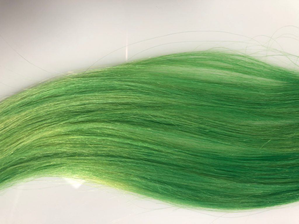 A strand of neon green hair