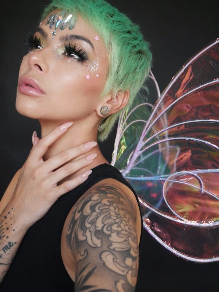 A person dressed as a fairy with Pastel Green Halloween hair