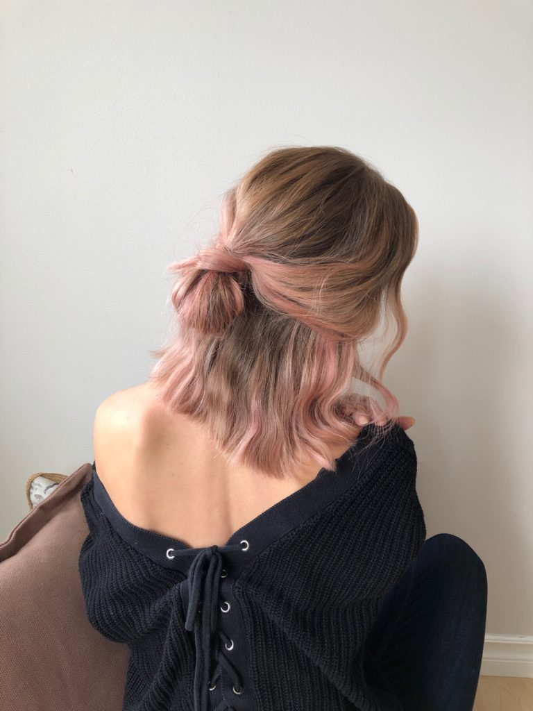 Image of the back of a person's head showing their short blonde and rose gold hair. 
