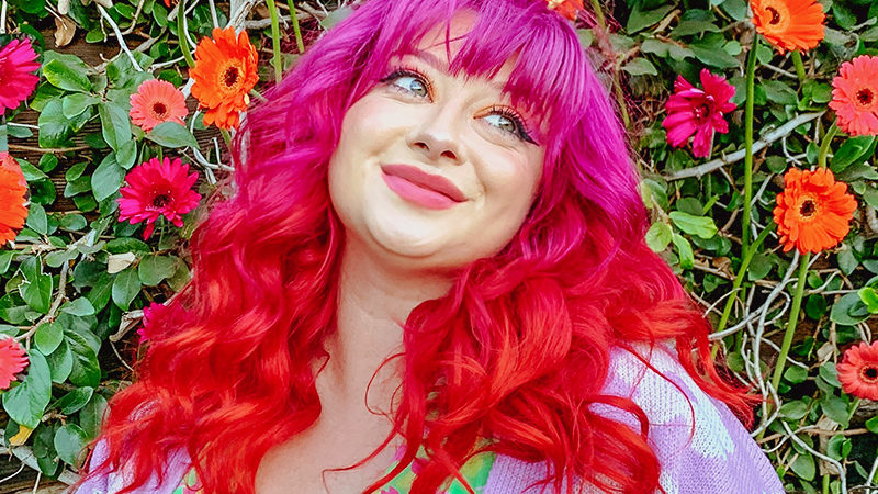 Person with long pink and red ombre hair