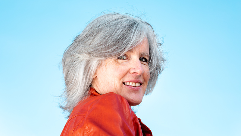 person with naturally gray hair and sky background